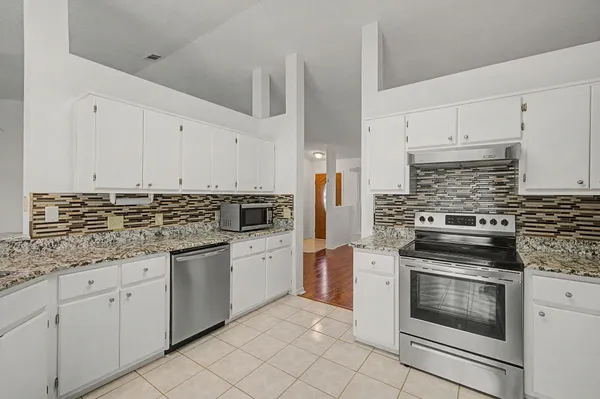 a kitchen with cabinets appliances and a sink