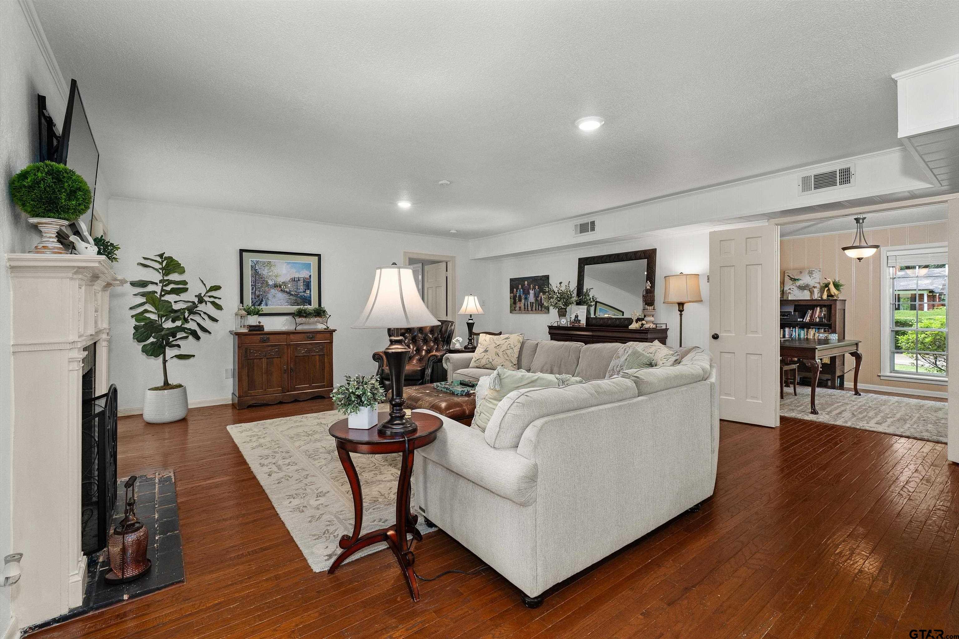16 Pegues Place Longview, TX 75601 - Photo 14 of 45 a living room with furniture a fireplace and a potted plant