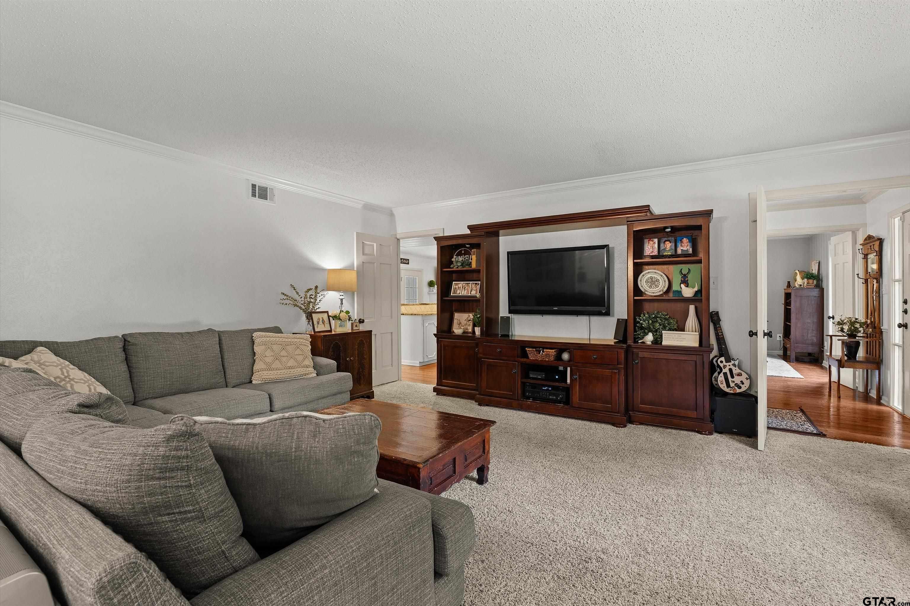 16 Pegues Place Longview, TX 75601 - Photo 22 of 45 a living room with furniture and a flat screen tv