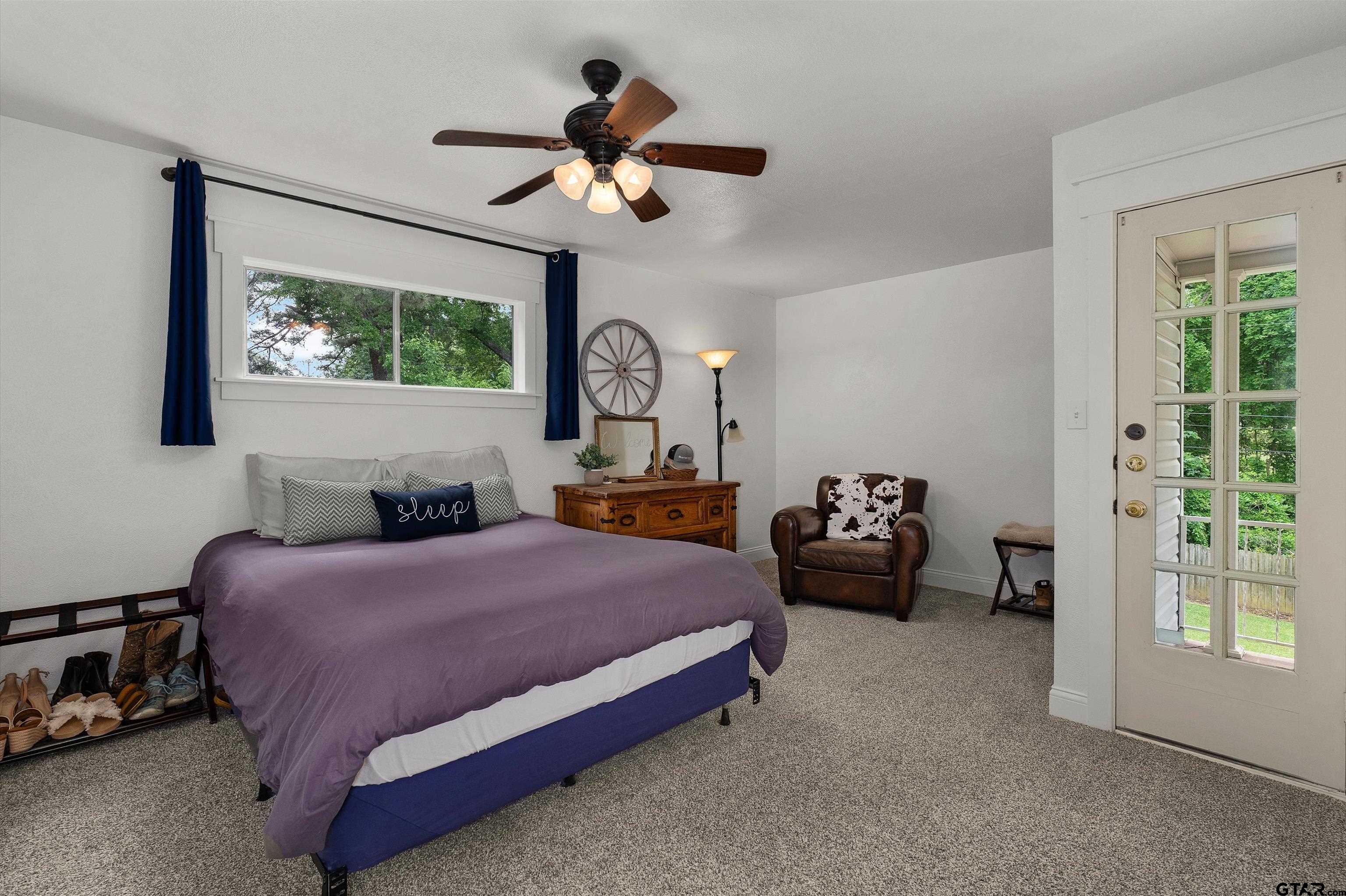 16 Pegues Place Longview, TX 75601 - Photo 30 of 45 a bedroom with a bed and a chandelier