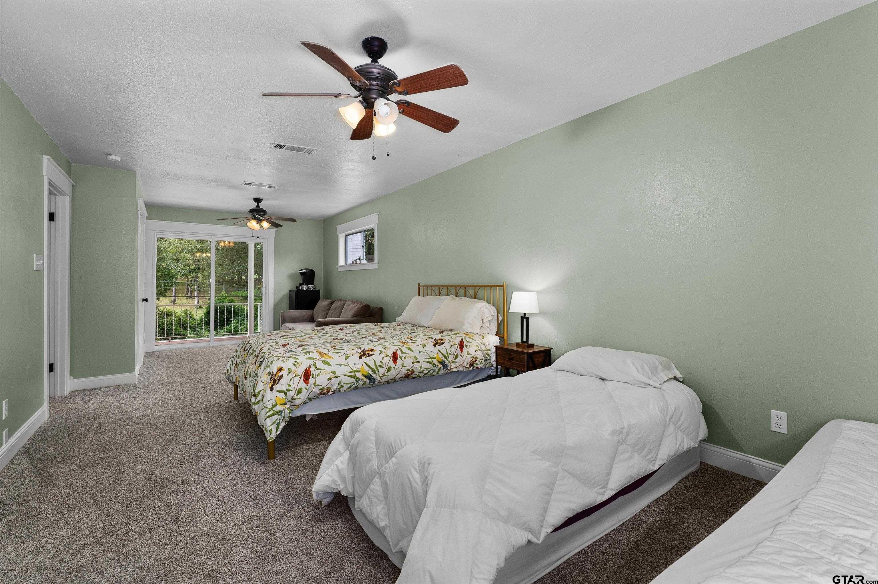 16 Pegues Place Longview, TX 75601 - Photo 35 of 45 a bedroom with two large bed and a large window