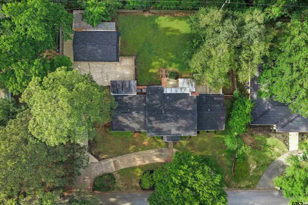 an aerial view of a house with a yard