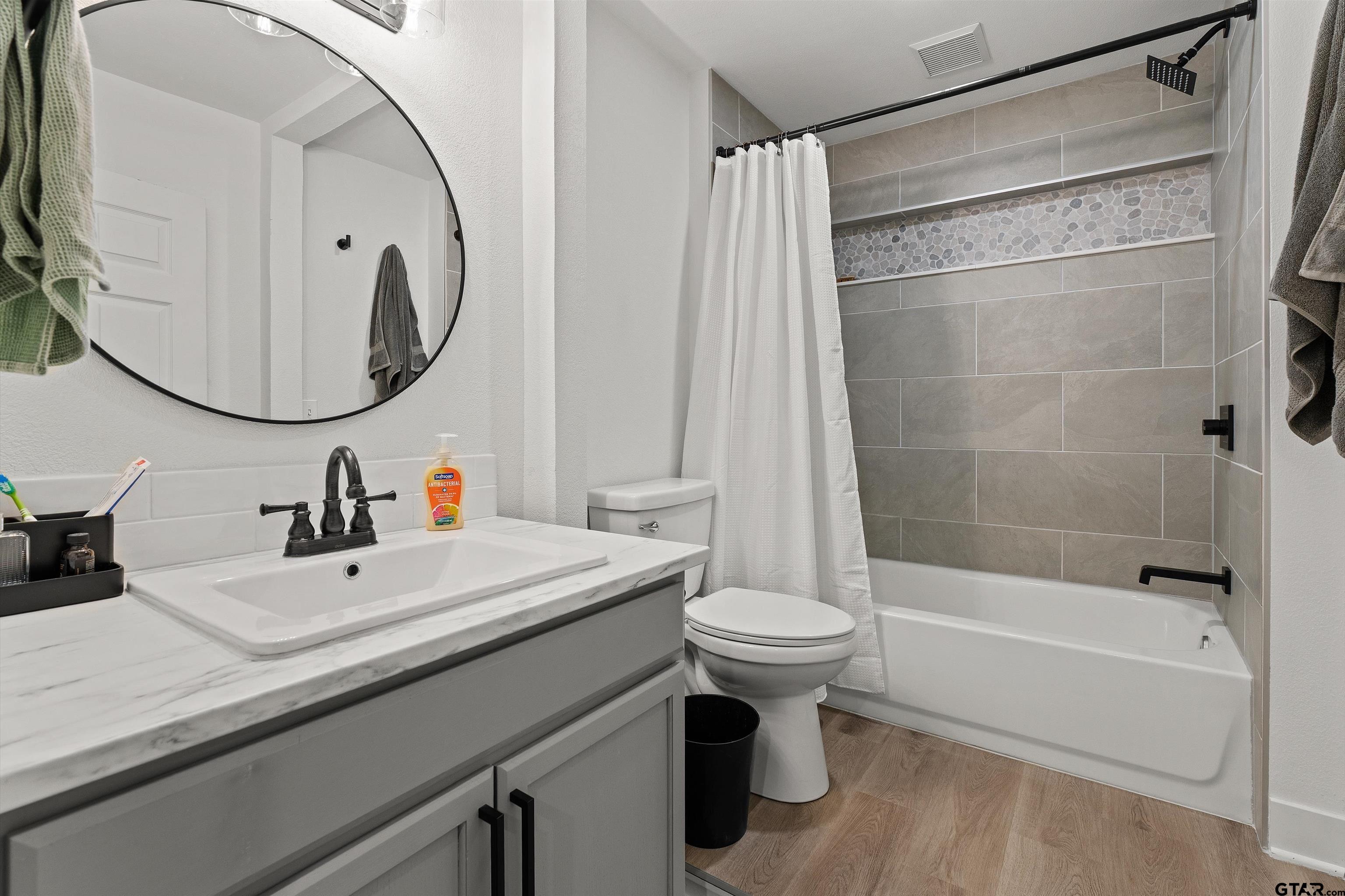 16 Pegues Place Longview, TX 75601 - Photo 42 of 45 a bathroom with a sink a toilet and a mirror