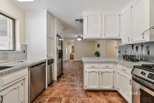 418 North Inyo Street Ridgecrest, CA 93555 - Photo 12 of 35 a kitchen with stainless steel appliances granite countertop a stove a sink and a refrigerator