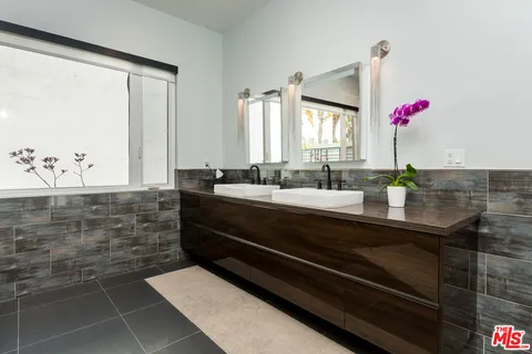 a bed room with a bed and a large window