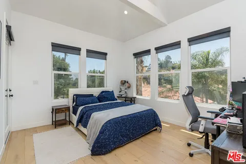 a bedroom with a large bed and a window