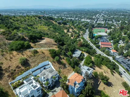 an aerial view of a house with a yard