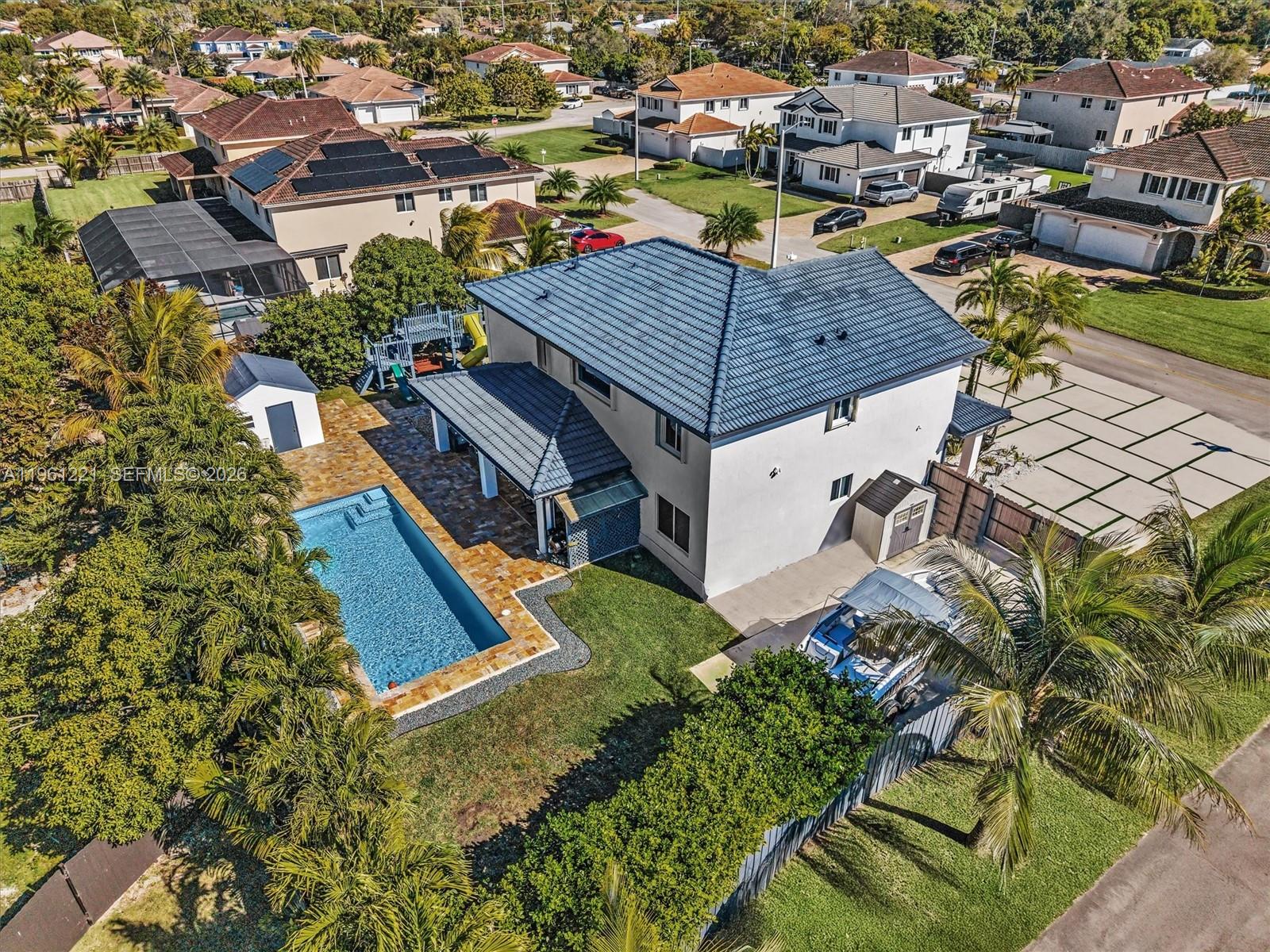 an aerial view of residential houses with yard