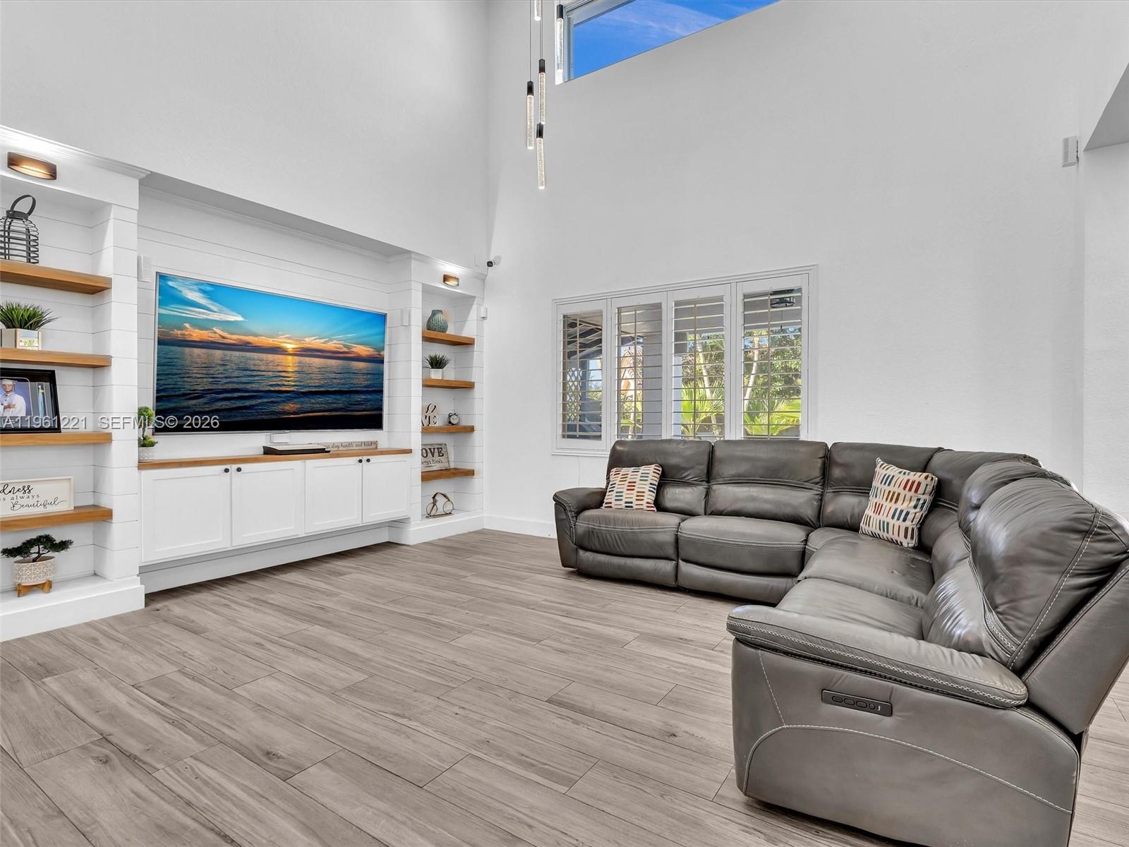 22690 Southwest 127th Court Miami, FL 33170 - Photo 14 of 52 a living room with furniture and a flat screen tv
