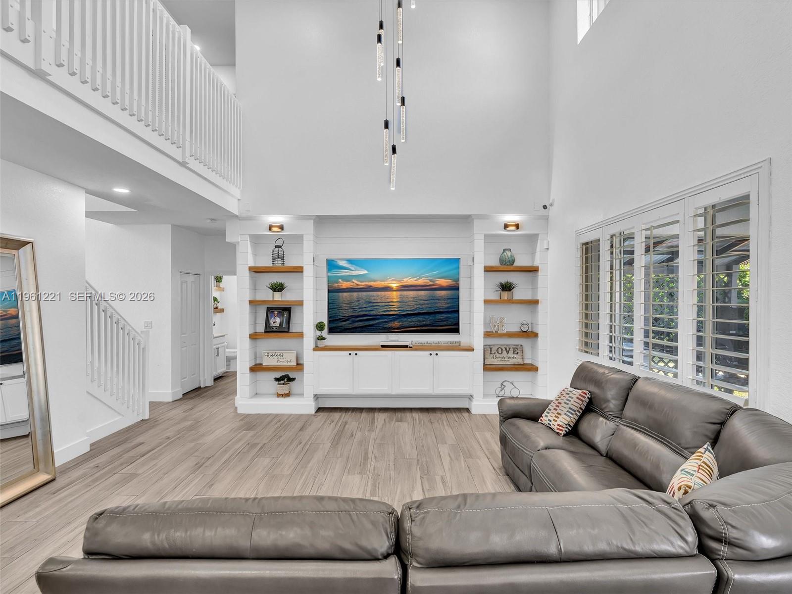 22690 Southwest 127th Court Miami, FL 33170 - Photo 15 of 52 a living room with furniture and a flat screen tv