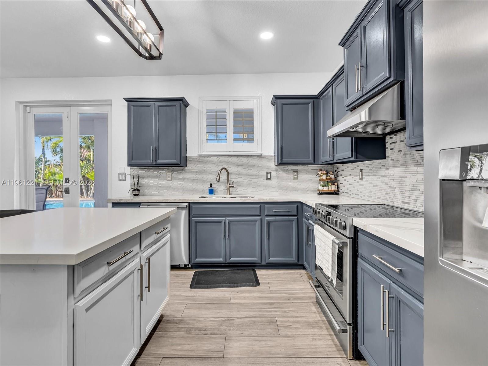 22690 Southwest 127th Court Miami, FL 33170 - Photo 20 of 52 a kitchen with stainless steel appliances granite countertop a sink stove and refrigerator