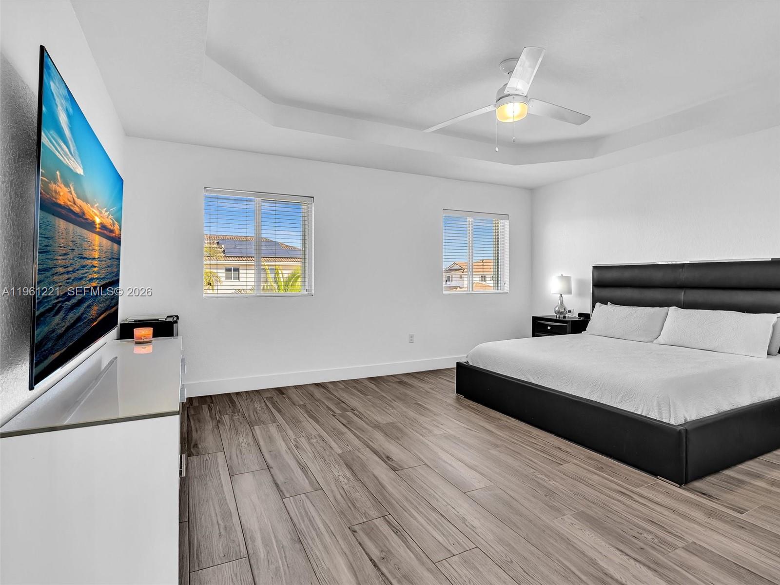 22690 Southwest 127th Court Miami, FL 33170 - Photo 22 of 52 a bedroom with a bed and a flat screen tv