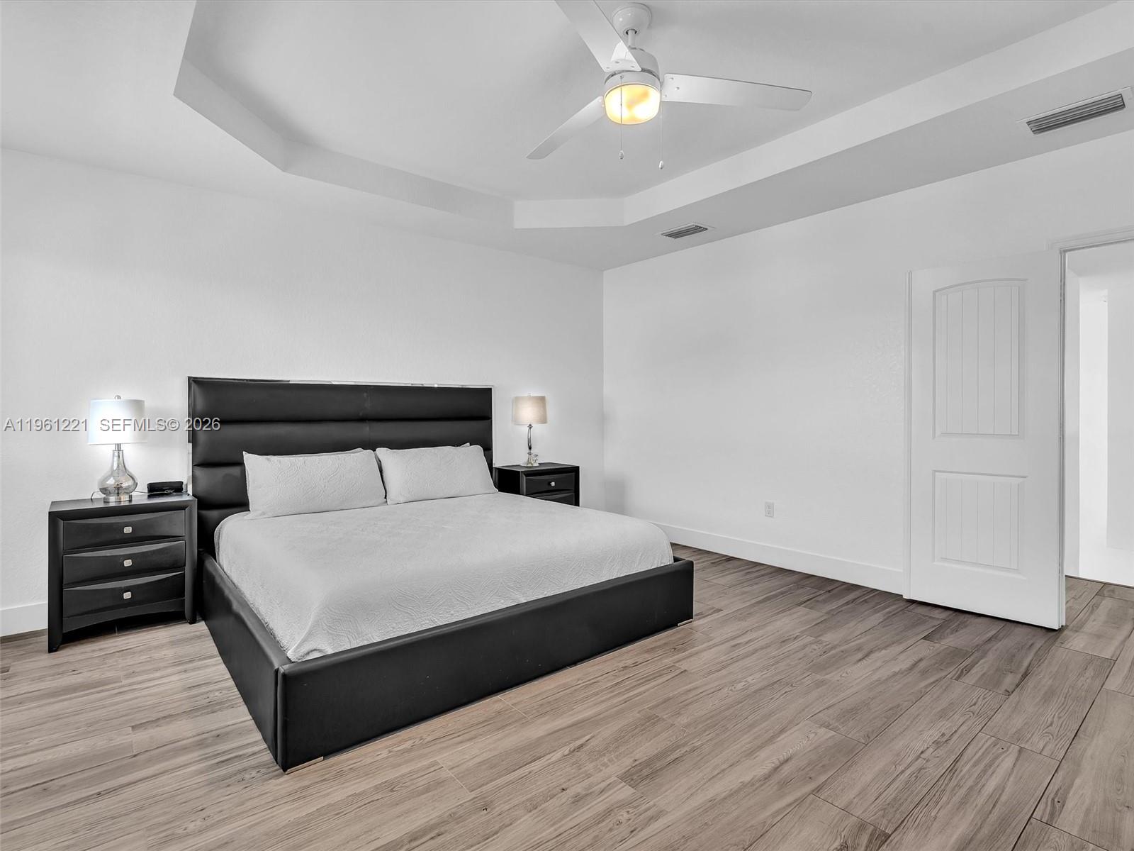 22690 Southwest 127th Court Miami, FL 33170 - Photo 23 of 52 a bedroom with a bed and wooden floor