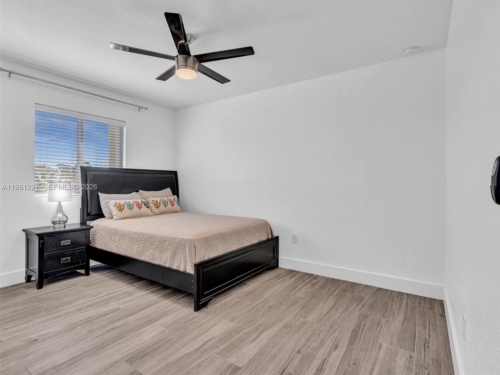22690 Southwest 127th Court Miami, FL 33170 - Photo 27 of 52 a bedroom with a bed and window