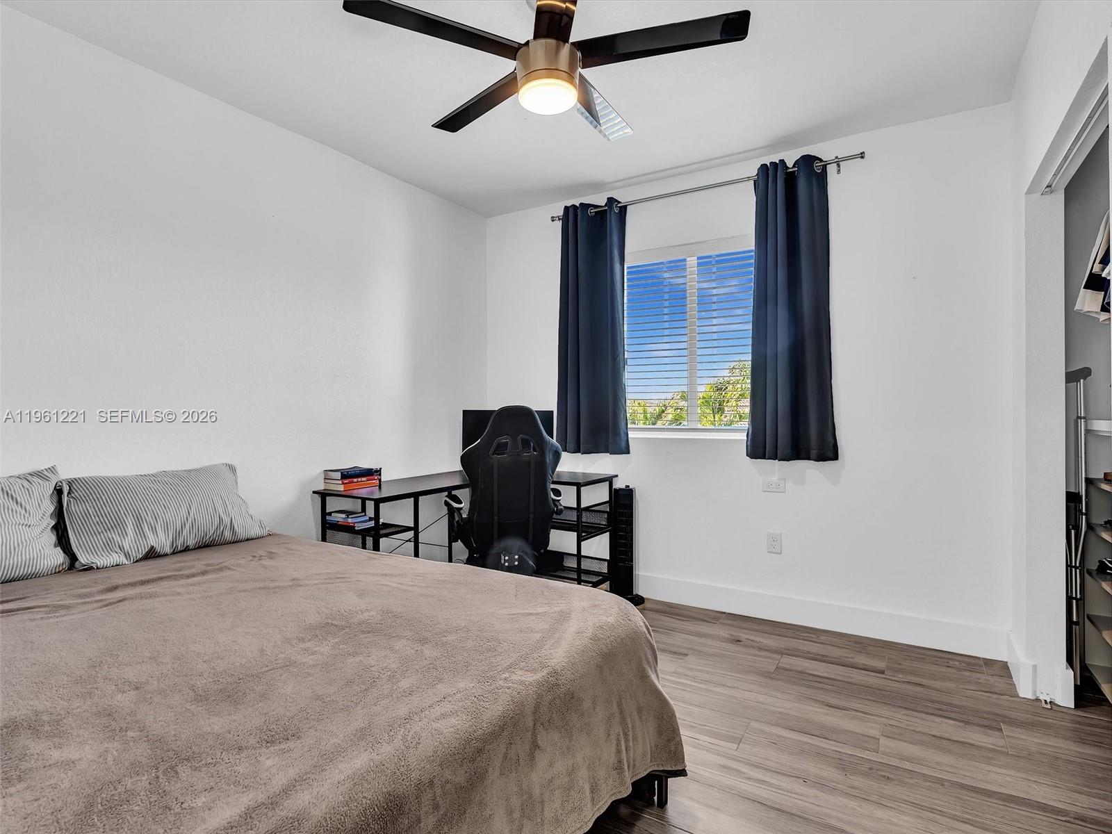 22690 Southwest 127th Court Miami, FL 33170 - Photo 31 of 52 a bedroom with a bed and a desk