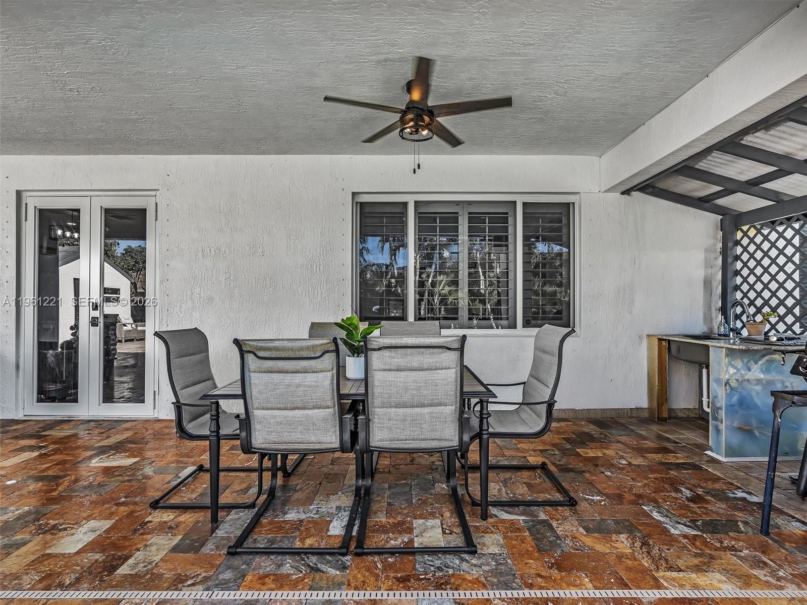 22690 Southwest 127th Court Miami, FL 33170 - Photo 43 of 52 a view of a patio with table and chairs and potted plants