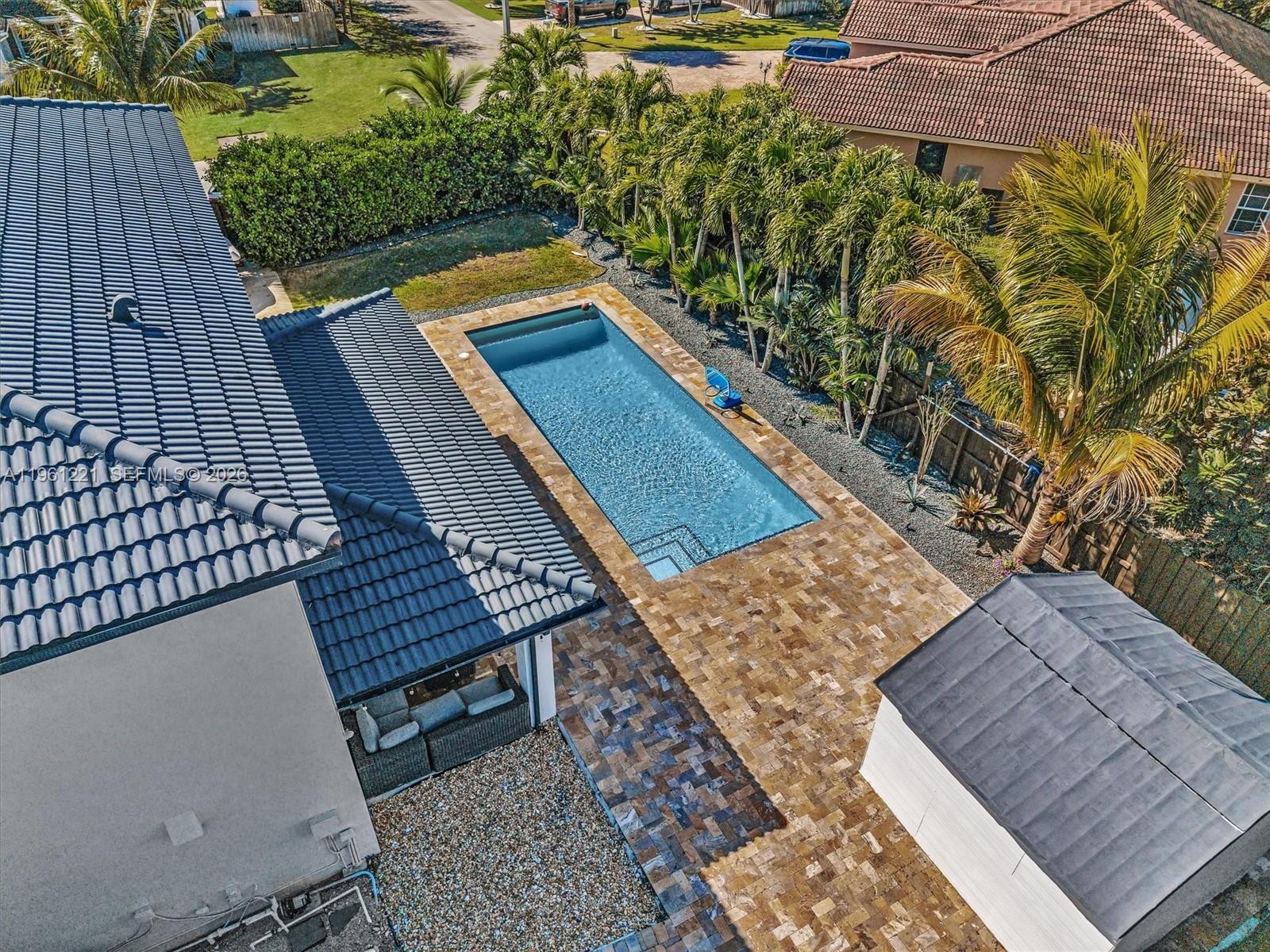 22690 Southwest 127th Court Miami, FL 33170 - Photo 46 of 52 a view of a roof deck with wooden floor and fence