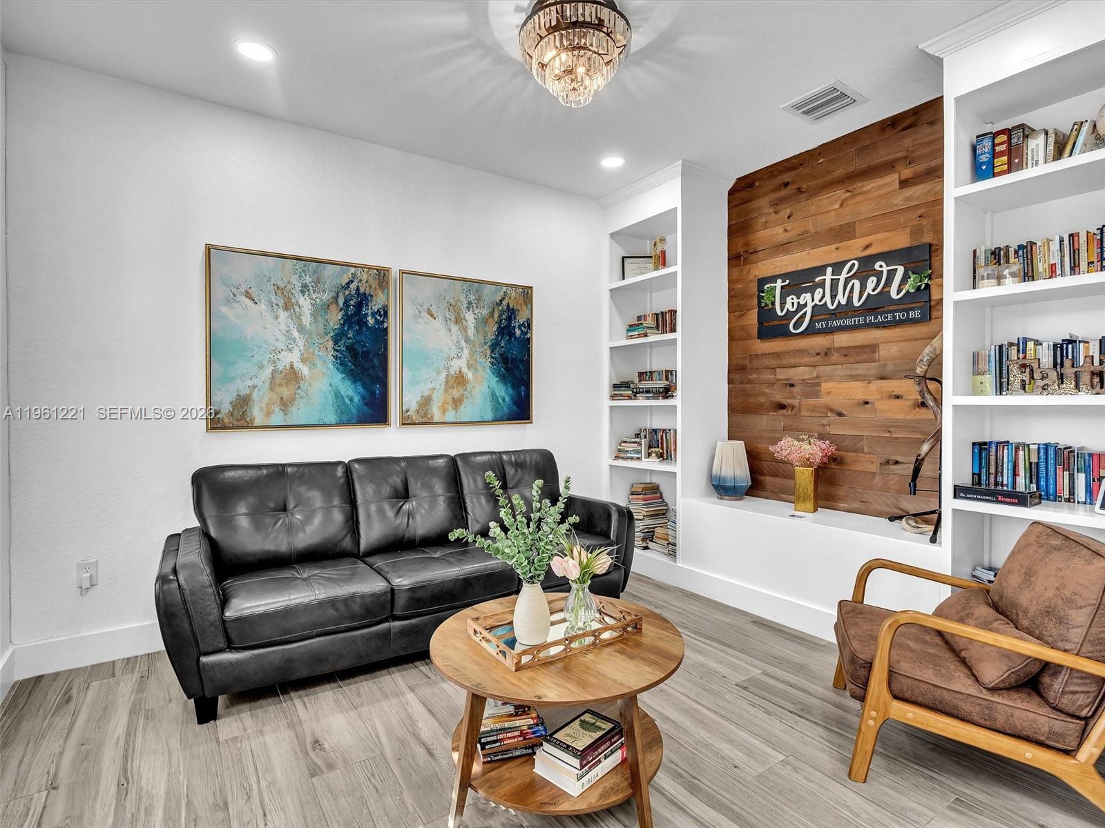 22690 Southwest 127th Court Miami, FL 33170 - Photo 10 of 52 a living room with furniture and a painting on the wall