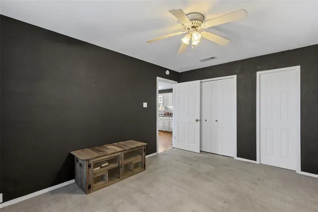 a bedroom with a bed and a mirror on dresser