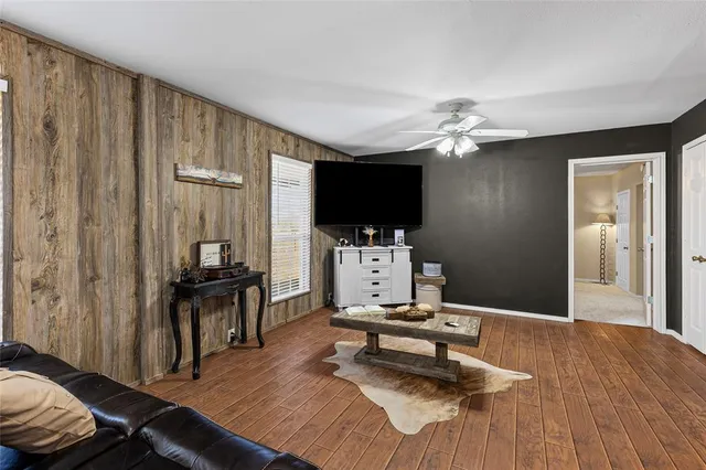 a bedroom with furniture and a flat screen tv