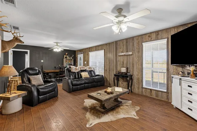a living room with furniture a fireplace and a window