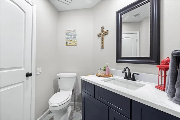 a spacious bedroom with a bed and a flat screen tv