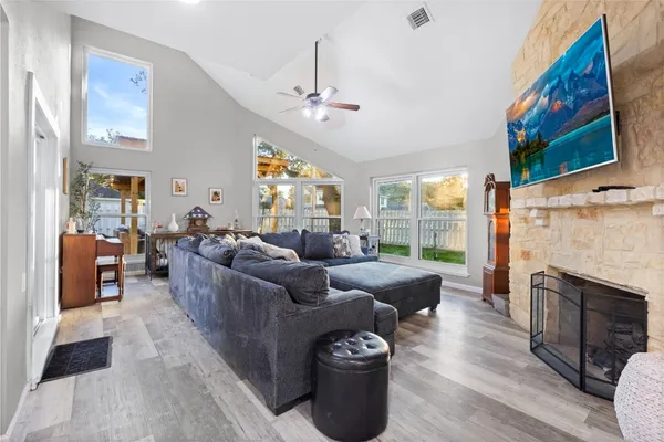 a living room with furniture a fireplace and a flat screen tv