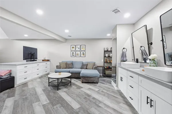 a bedroom with a large bed and a flat screen tv