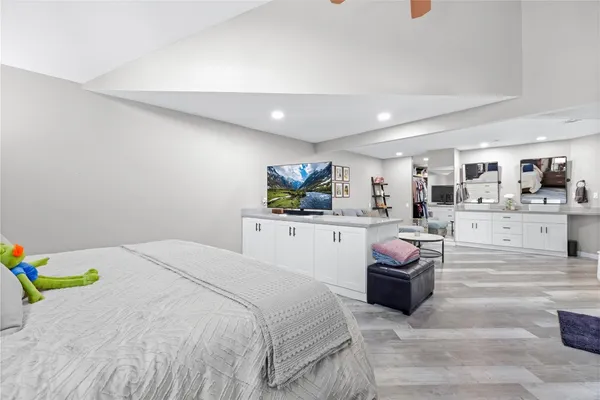 a bedroom with a bed gym equipment and a large window