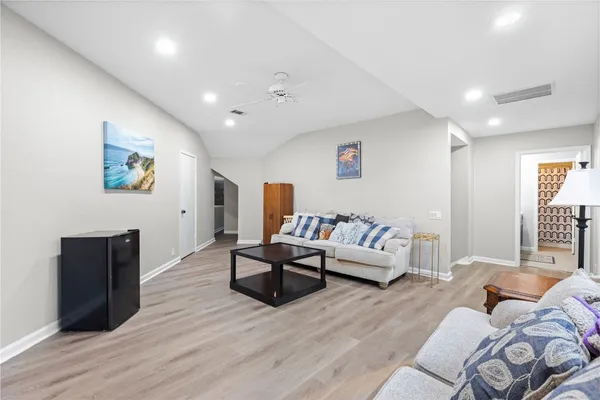 a view of a patio with table and chairs potted plants with wooden floor and fence