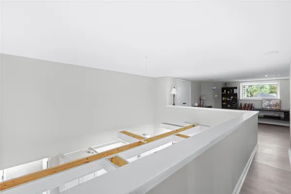 a view of roof deck with wooden floor and furniture