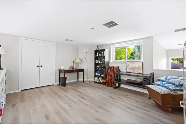 a bedroom with a bed and wooden floor