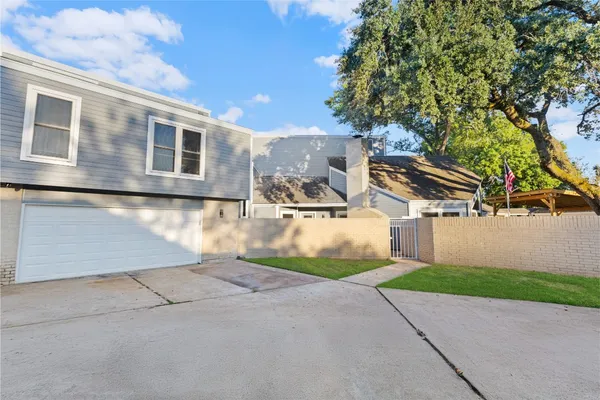 a view of a house with a yard and garage