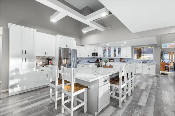 a kitchen with lots of counter top space and furniture
