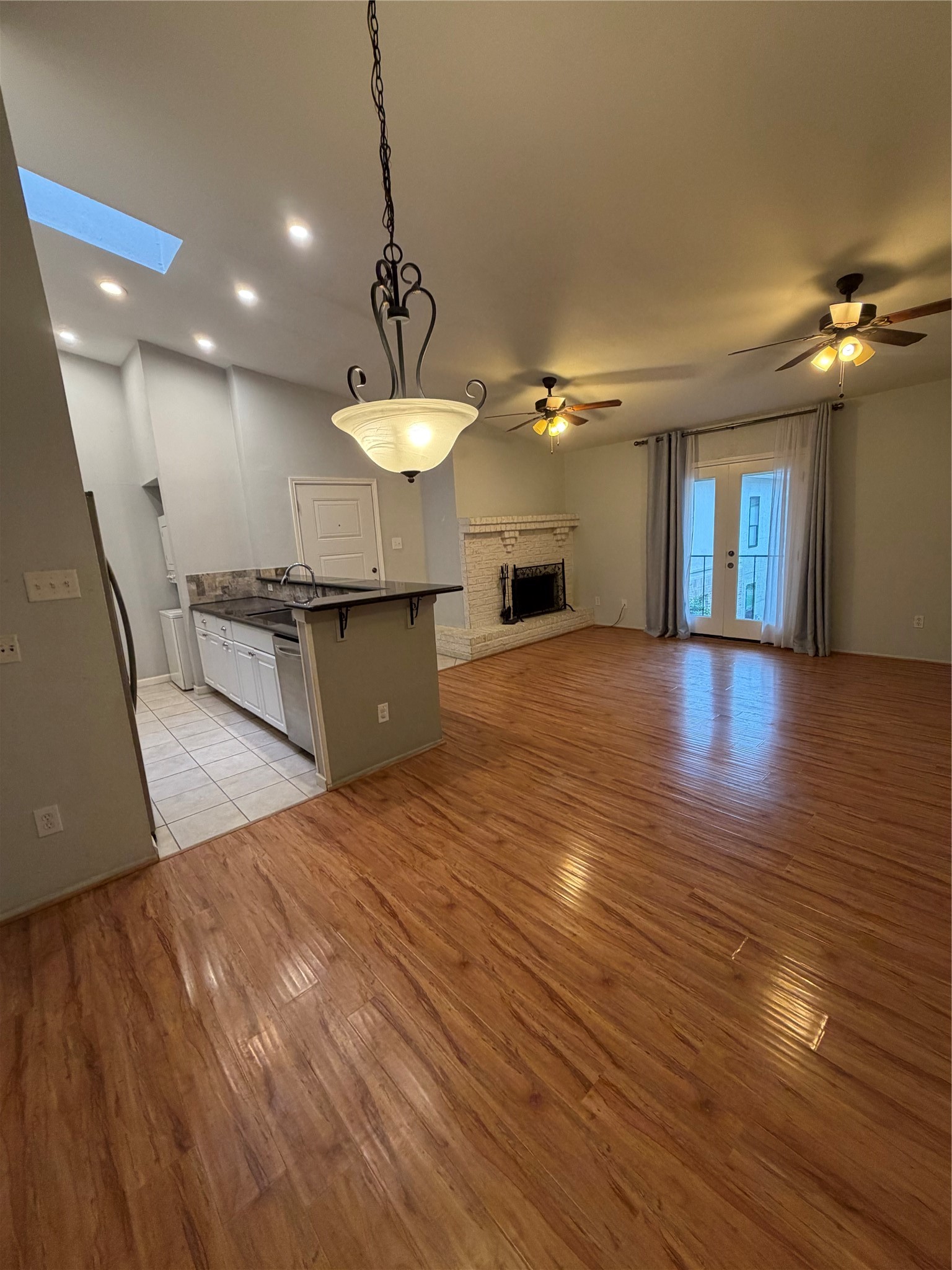 2425 Augusta Drive, Unit 36 Houston, TX 77057 - Photo 15 of 24 a view of a living room a kitchen and a chandelier
