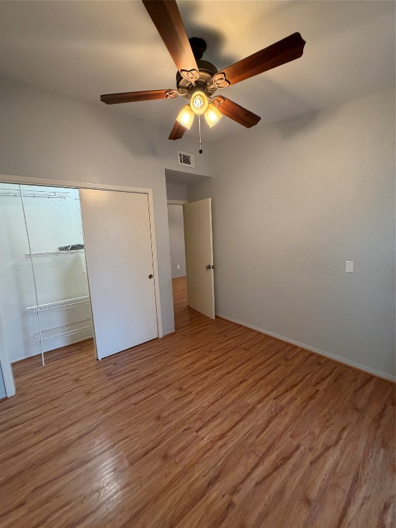 2425 Augusta Drive, Unit 36 Houston, TX 77057 - Photo 24 of 24 an empty room with wooden floor and chandelier fan