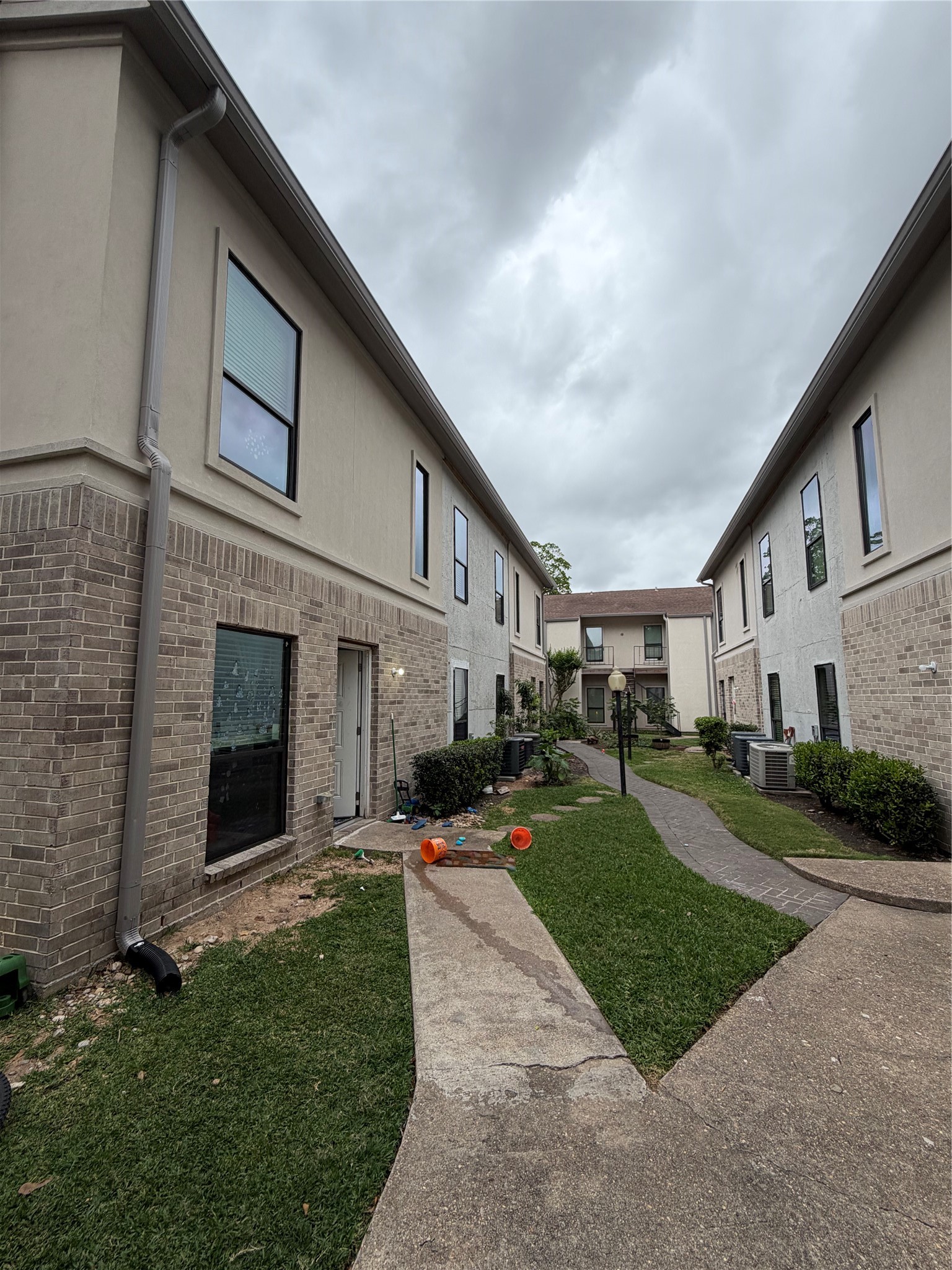 2425 Augusta Drive, Unit 36 Houston, TX 77057 - Photo 3 of 24 a front view of a house with a yard and garage