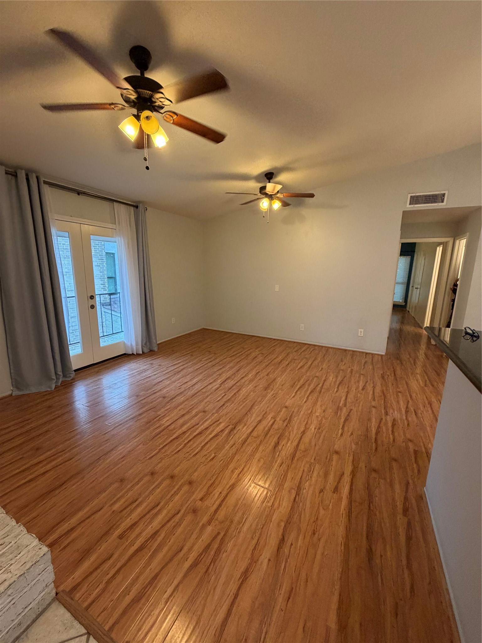 2425 Augusta Drive, Unit 36 Houston, TX 77057 - Photo 6 of 24 wooden floor in an empty room with a window