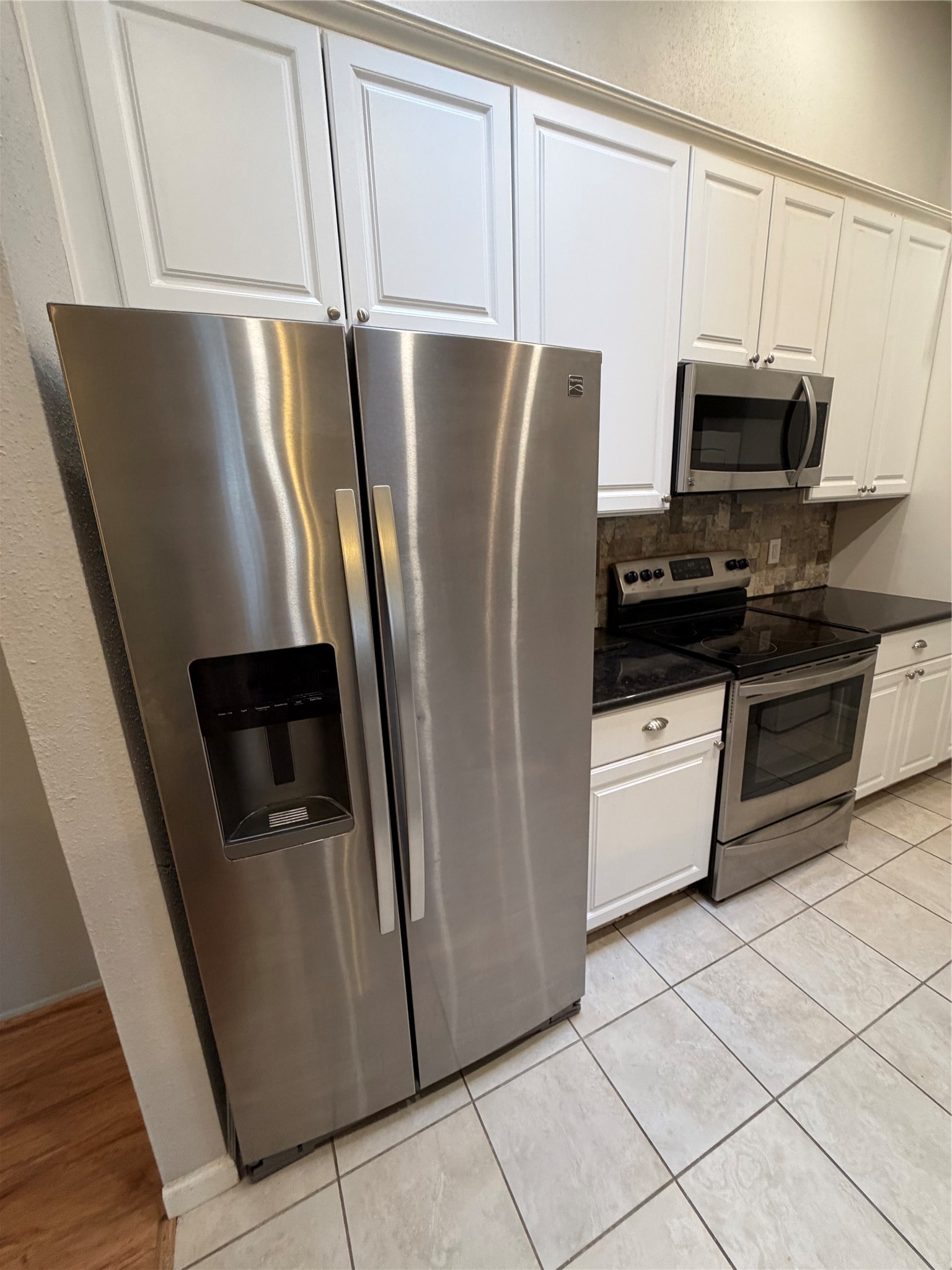 2425 Augusta Drive, Unit 36 Houston, TX 77057 - Photo 10 of 24 a kitchen with stainless steel appliances a refrigerator sink and microwave