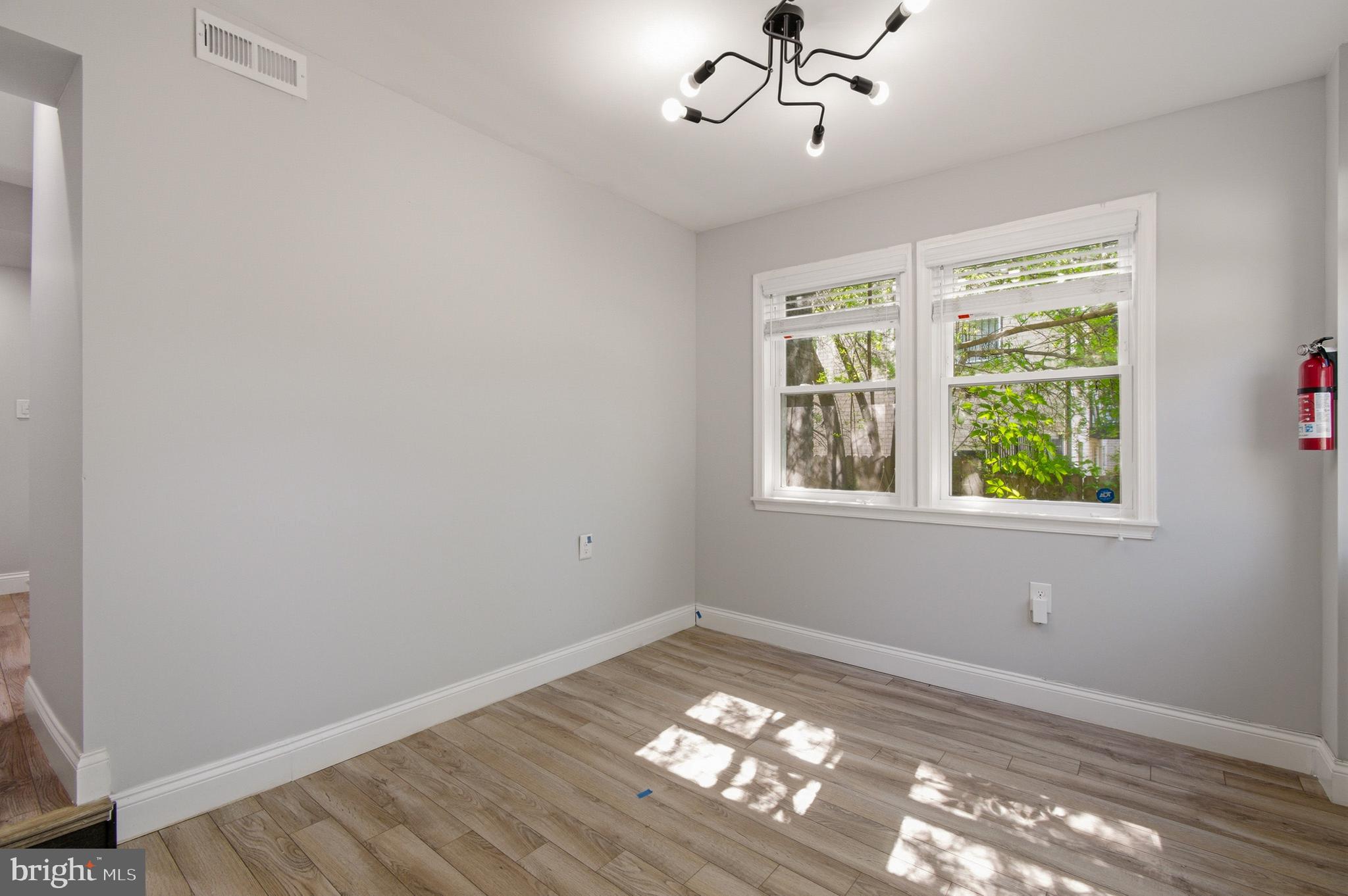 1527 Morris Road Southeast Washington, DC 20020 - Photo 13 of 22 a view of empty room with wooden floor and fan