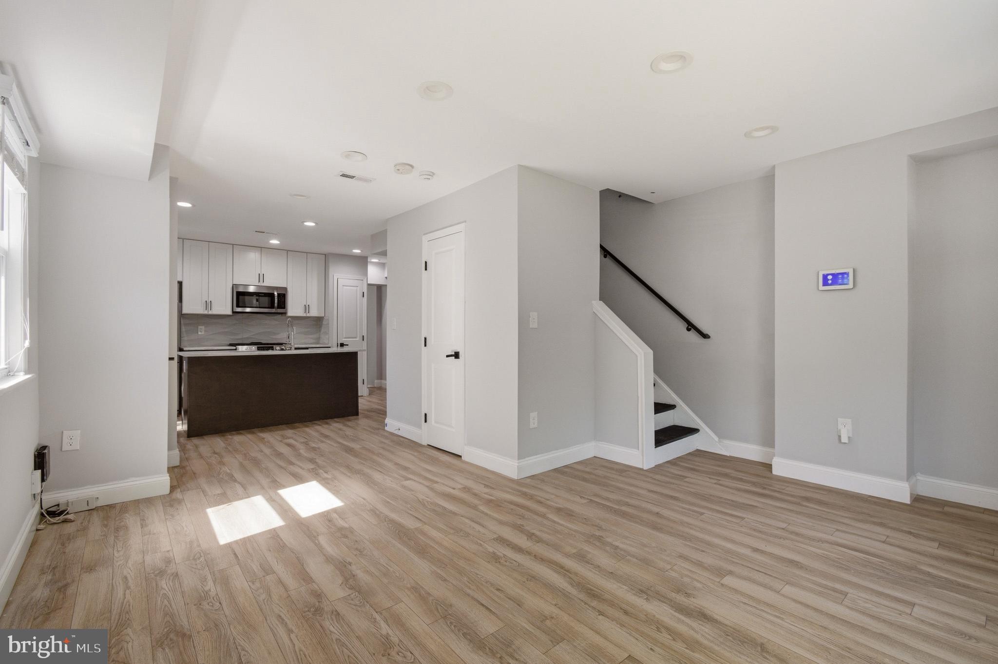 1527 Morris Road Southeast Washington, DC 20020 - Photo 2 of 22 a view of an empty room with wooden floor and staircase