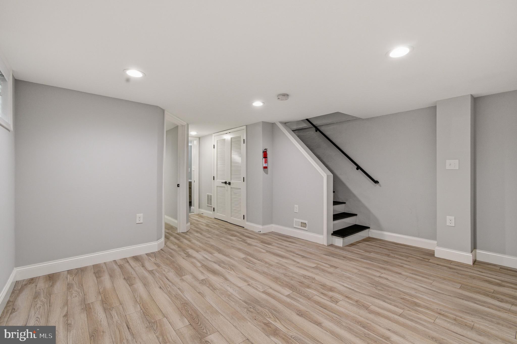 1527 Morris Road Southeast Washington, DC 20020 - Photo 5 of 22 an empty room with wooden floor and stairs