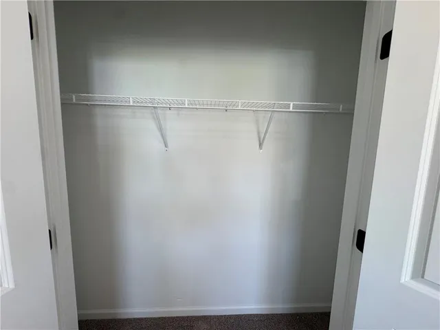 a large kitchen with stainless steel appliances granite countertop a stove a sink a refrigerator and a wooden floor