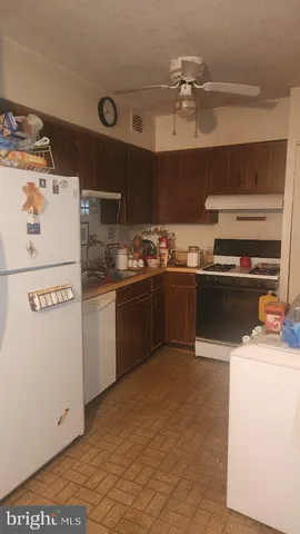 a kitchen with a sink a stove and cabinets