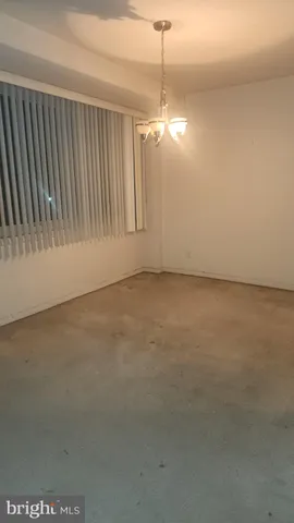 a view of empty room with floor to ceiling window