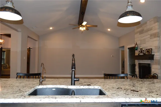 a kitchen with stainless steel appliances granite countertop a refrigerator and a sink