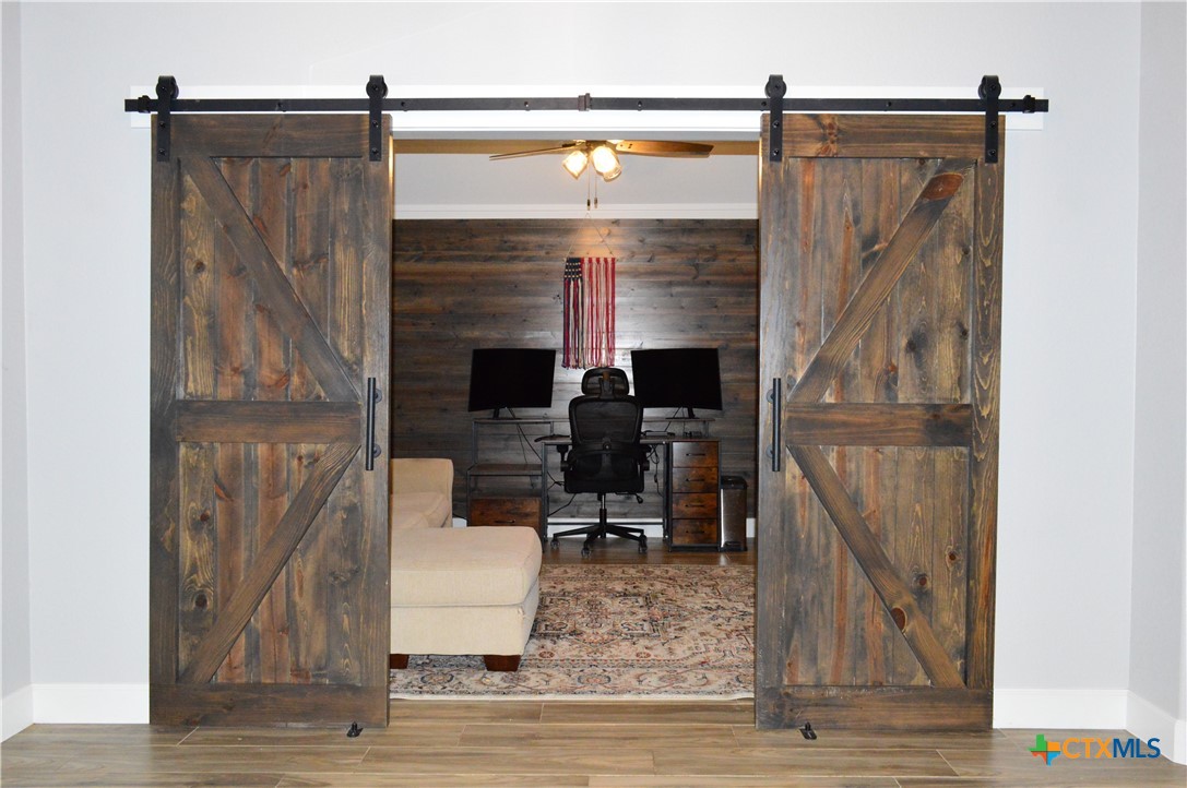 1026 County Road 3152 Kempner, TX 76539 - Photo 15 of 48 Barn Doors to the Den/Office * Or add a closet to make a 5th bedroom. * Wood-Look Tile Flooring
