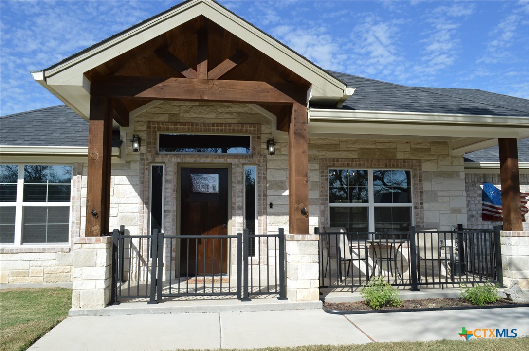 1026 County Road 3152 Kempner, TX 76539 - Photo 2 of 48 Elegant Front Entry ** 22' 10" X 6' Covered Front Porch with Decorative Wrought Iron Fencing ** Sidewalk to the Driveway