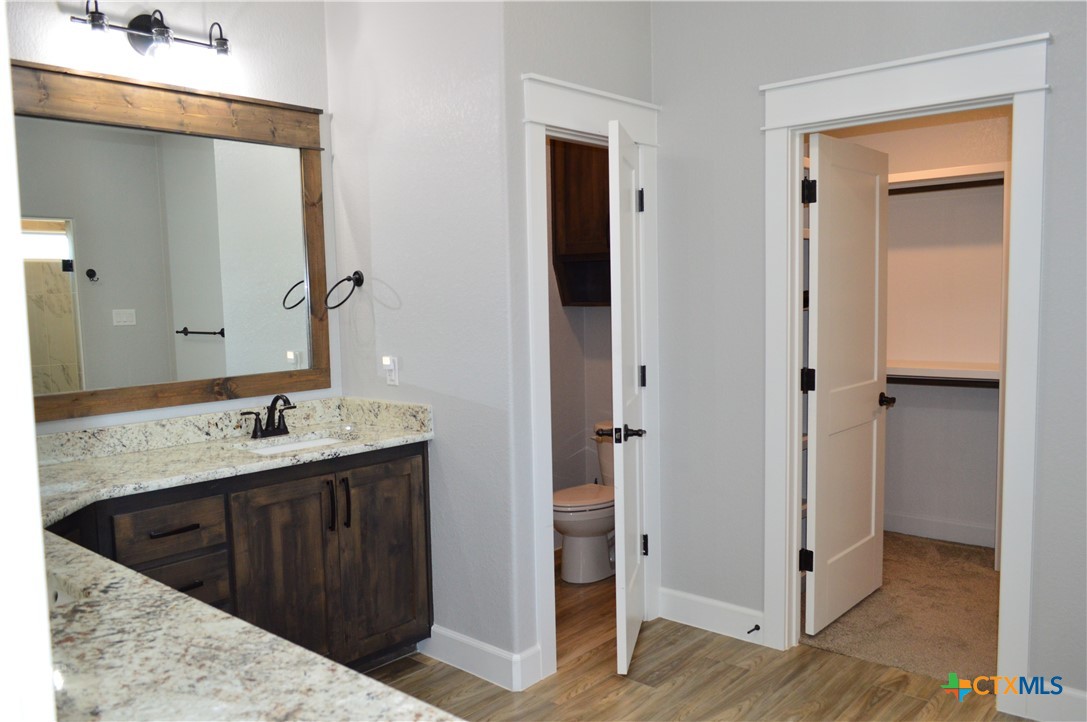 1026 County Road 3152 Kempner, TX 76539 - Photo 20 of 48 The master bath has granite countertops with two individual sink areas, framed mirrors, soaker tub, separate shower and private water closet.