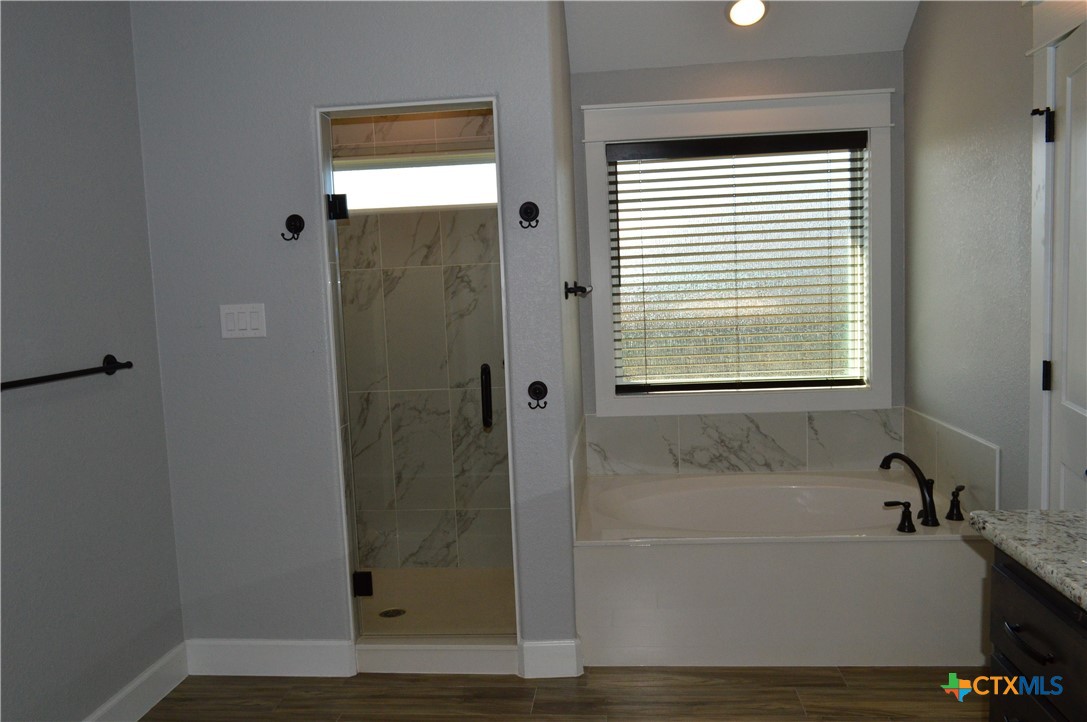 1026 County Road 3152 Kempner, TX 76539 - Photo 21 of 48 The master bath has granite countertops with two individual sink areas, framed mirrors, lots of storage, soaker tub, separate shower, and private water closet.